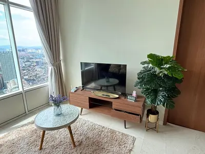 a living room with a tv and a large window at URBAN SKY HOME NEAR KLCC Complementary Breakfast in Kuala Lumpur