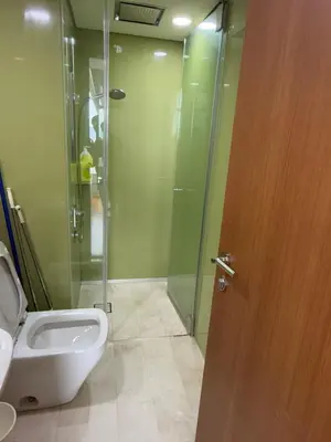 a bathroom with a shower and a toilet and a door at URBAN SKY HOME NEAR KLCC Complementary Breakfast in Kuala Lumpur