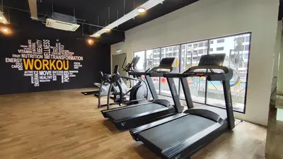 a gym with several tread machines in a room at LSH33 Residence Sentul KL by HomeBrickz in Kuala Lumpur