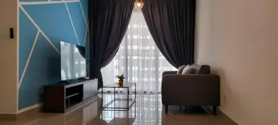 a living room with a chair and a television at LSH33 Residence Sentul KL by HomeBrickz in Kuala Lumpur