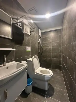 a bathroom with a white toilet and a sink at SS Grey inn Bukit Bintang in Kuala Lumpur