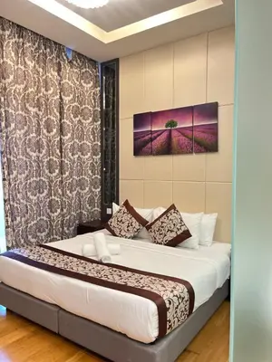 a bedroom with a large bed in a room at Dorsett Residence Service Suites at Kuala Lumpur in Kuala Lumpur