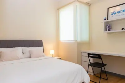 a bedroom with a bed and a desk and a chair at Publika Mont Kiara City View Suite - 8KM to KLCC in Kuala Lumpur