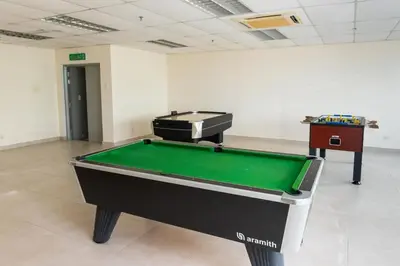 a pool table in an empty room with a pool table at Publika Mont Kiara City View Suite - 8KM to KLCC in Kuala Lumpur