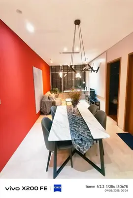 a dining room and living room with a red wall at Sky suites KLCC by Kuala Lumpur Family Room Stay in Kuala Lumpur