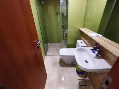 a bathroom with a sink and a toilet and a shower at Sky suites KLCC by Kuala Lumpur Family Room Stay in Kuala Lumpur