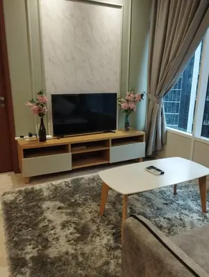 a living room with a tv and a coffee table at Sky suites KLCC by Kuala Lumpur Family Room Stay in Kuala Lumpur