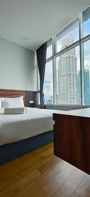 a bedroom with a large bed and a large window at Sky suites KLCC by Kuala Lumpur Family Room Stay in Kuala Lumpur