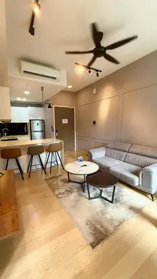 a living room with a couch and a ceiling fan at Star Suites KLCC by flixses in Kuala Lumpur