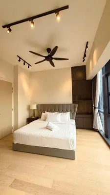 a bedroom with a bed with a ceiling fan at Star Suites KLCC by flixses in Kuala Lumpur