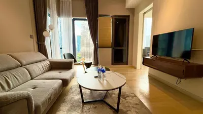 a living room with a couch and a tv at Star Suites KLCC by flixses in Kuala Lumpur