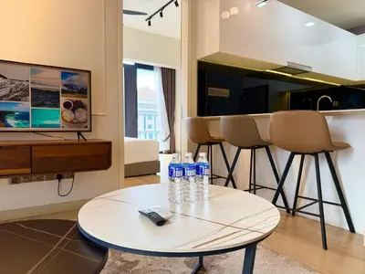 a living room with a table and some bottles of water at Star Suites KLCC by flixses in Kuala Lumpur