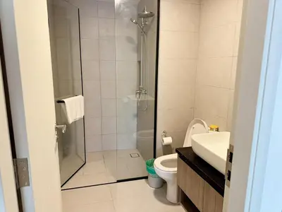 a bathroom with a shower and a toilet and a sink at The Atrium at Jalan Ampang by OKBnB - Spacious Modern 3Bedroom Family Suite 3 mins to KLCC in Kuala Lumpur