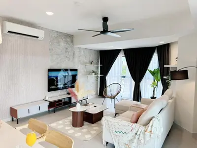 a living room with a couch and a tv at The Atrium at Jalan Ampang by OKBnB - Spacious Modern 3Bedroom Family Suite 3 mins to KLCC in Kuala Lumpur