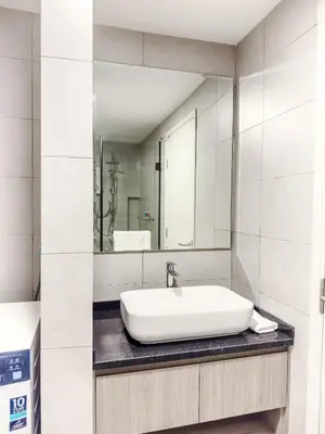 a white bathroom with a sink and a mirror at The Atrium Ampang by OKBnB - Family Suite 3-Minute Access to the Heart of KL in Kuala Lumpur