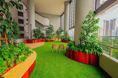 a room with plants and chairs in a building at The Atrium Ampang by OKBnB - Family Suite 3-Minute Access to the Heart of KL in Kuala Lumpur