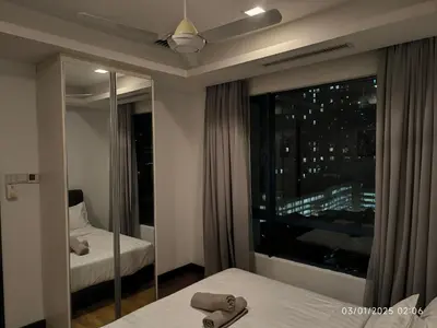 a bedroom with a window with a view of a city at 0111 Sweet Home-Casa Residency 2R 2B City View in Kuala Lumpur