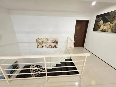 a room with a table and two pictures on the wall at Bungalow Perkasa in Kuala Lumpur