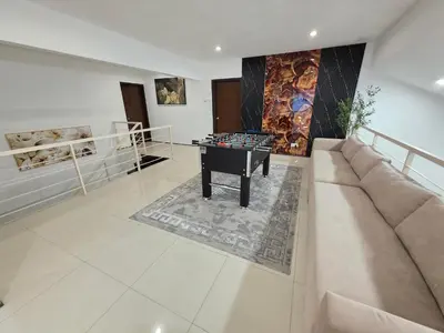 a living room with a couch and a table at Bungalow Perkasa in Kuala Lumpur