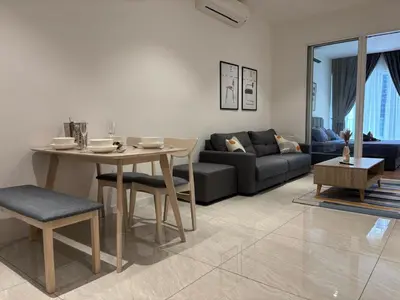 a living room with a table and a couch at Quill Luxe Stay - KLCC in Kuala Lumpur