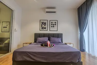 a bedroom with a large bed with purple sheets at Quill Luxe Stay - KLCC in Kuala Lumpur