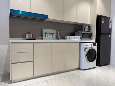 a kitchen with a washer and a washing machine at Quill Luxe Stay - KLCC in Kuala Lumpur