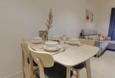a dining room table and chairs with a white table and a couch at Quill Luxe Stay - KLCC in Kuala Lumpur