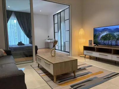 a living room with a couch and a tv at Quill Luxe Stay - KLCC in Kuala Lumpur