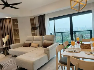 a living room with a couch and a table at The Atrium at Jalan Ampang by OKBnB - Luxury 3 Bedroom Family Suite with Balcony, 3 mins to KLCC in Kuala Lumpur