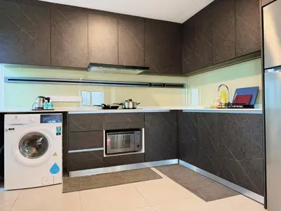 a kitchen with a washing machine and a washer at The Atrium at Jalan Ampang by OKBnB - Luxury 3 Bedroom Family Suite with Balcony, 3 mins to KLCC in Kuala Lumpur