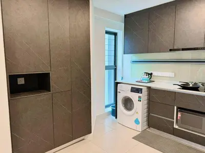 a kitchen with a washer and a washing machine at The Atrium at Jalan Ampang by OKBnB - Luxury 3 Bedroom Family Suite with Balcony, 3 mins to KLCC in Kuala Lumpur