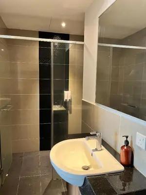 a bathroom with a sink and a mirror at Mid Valley & The Sphere BTC in Kuala Lumpur