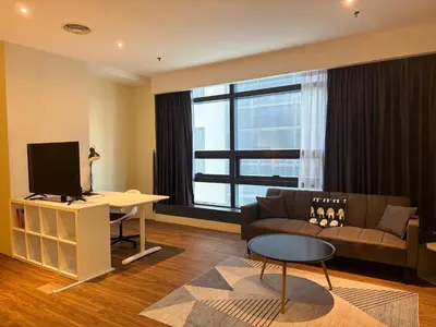 a living room with a couch and a television at Mid Valley & The Sphere BTC in Kuala Lumpur