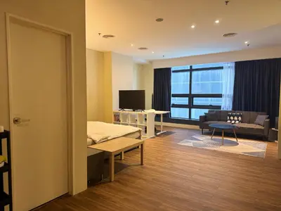 a room with a bed and a couch and a television at Mid Valley & The Sphere BTC in Kuala Lumpur