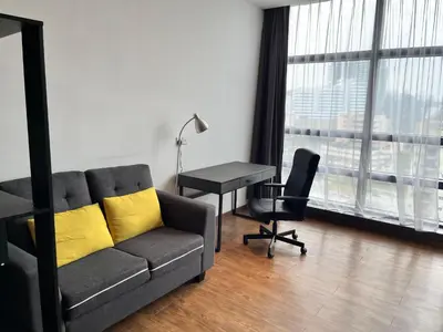a living room with a couch and a desk and window at Mid Valley & The Sphere BTC in Kuala Lumpur