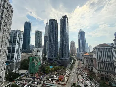a city with tall buildings and a street with cars at Royce Residences KLCC by WSD in Kuala Lumpur
