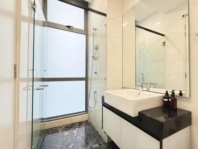 a bathroom with a sink and a glass shower at Royce Residences KLCC by WSD in Kuala Lumpur