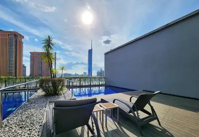 a balcony with chairs and a swimming pool on a building at Kuala Lumpur Bintang Fairlane #157 TRX in Kuala Lumpur
