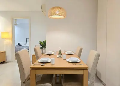 a dining room with a wooden table and chairs at Kuala Lumpur Bintang Fairlane #157 TRX in Kuala Lumpur