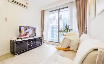 a living room with a couch and a tv at Bukit Bintang Fairlane Residence #18 Kuala Lumpur in Kuala Lumpur