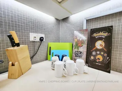 a room with a table with cups and a book at Bukit Bintang Fairlane Residence #18 Kuala Lumpur in Kuala Lumpur