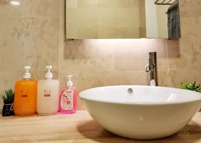 a sink with two bottles of soap and a mirror at Bukit Bintang Fairlane Residence #18 Kuala Lumpur in Kuala Lumpur