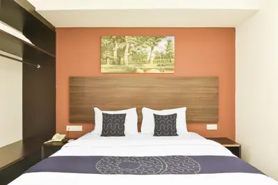 a bedroom with a large bed with orange walls at Palette KL Sentral near Pudu LRT formerly RPC Blissful Homes in Kuala Lumpur