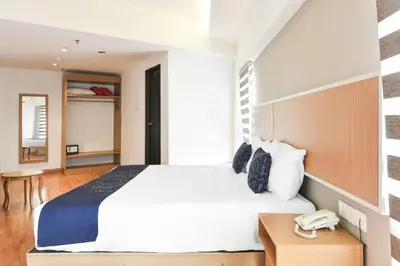 a bedroom with a large white bed and a telephone at Palette KL Sentral near Pudu LRT formerly RPC Blissful Homes in Kuala Lumpur