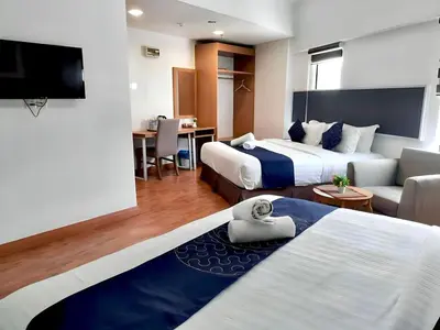 a hotel room with two beds and a couch at Palette KL Sentral near Pudu LRT formerly RPC Blissful Homes in Kuala Lumpur