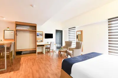 a hotel room with a bed and a desk at Palette KL Sentral near Pudu LRT formerly RPC Blissful Homes in Kuala Lumpur