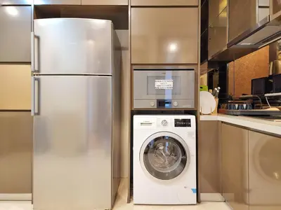 a stainless steel refrigerator and a washing machine in a kitchen at Dorsett Residence Kuala Lumpur #08 TRX KLCC Pavilion in Kuala Lumpur