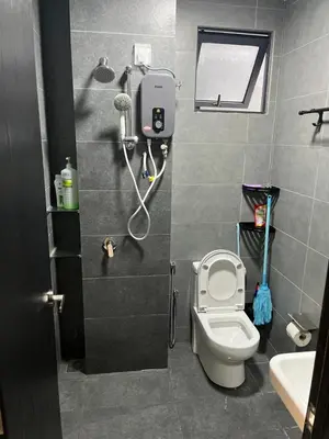 a small bathroom with a toilet and a sink at Neu Suites 2 Room Home Stay in Kuala Lumpur