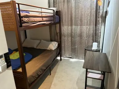 a small room with a bunk bed and a table at Neu Suites 2 Room Home Stay in Kuala Lumpur