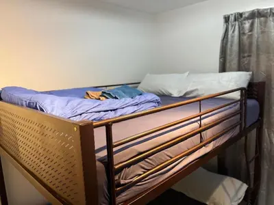 a bunk bed with a blue sheet and a mattress at Neu Suites 2 Room Home Stay in Kuala Lumpur